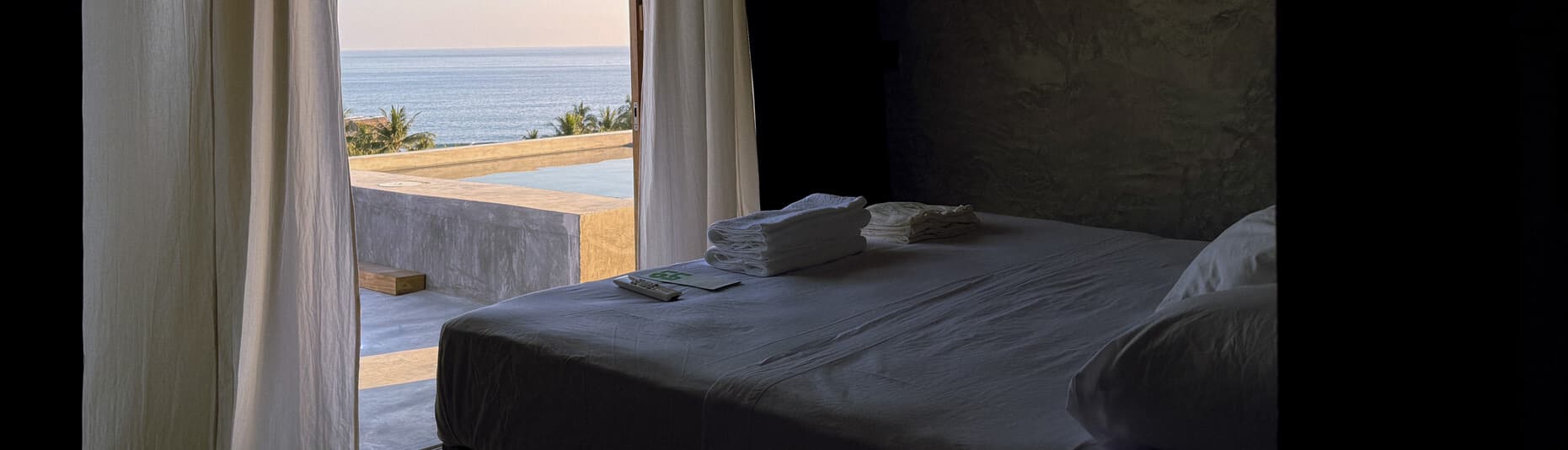 El Chachalaca room at Hotel Lalo Zipolite with ocean-view terrace, minimalist concrete design, and serene coastal ambiance.
